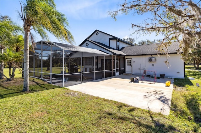 rear view of property with a lanai, a yard, and a patio