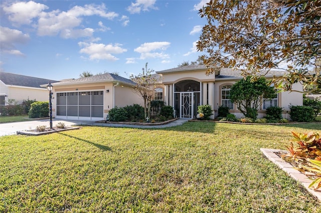 ranch-style home featuring a garage and a front lawn