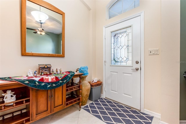 foyer featuring ceiling fan, plenty of natural light, and light tile patterned floors