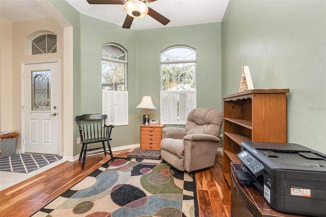 sitting room with hardwood / wood-style flooring and ceiling fan