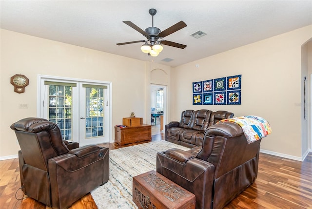 living room with ceiling fan, french doors, a textured ceiling, and hardwood / wood-style flooring