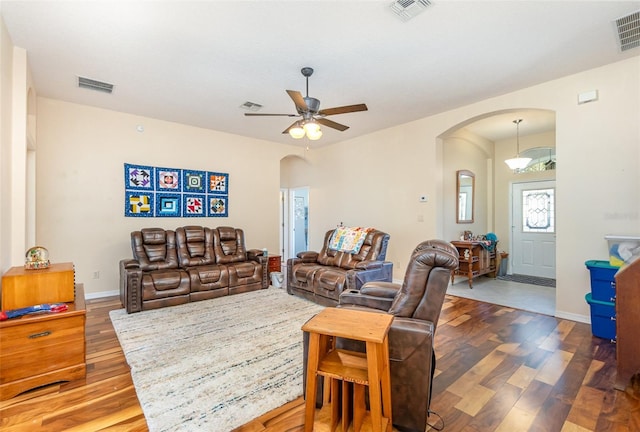 living room featuring ceiling fan and hardwood / wood-style floors