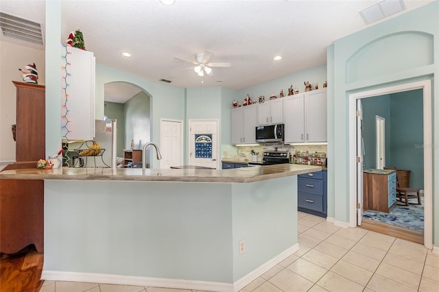 kitchen with kitchen peninsula, white cabinets, ceiling fan, blue cabinetry, and black electric range