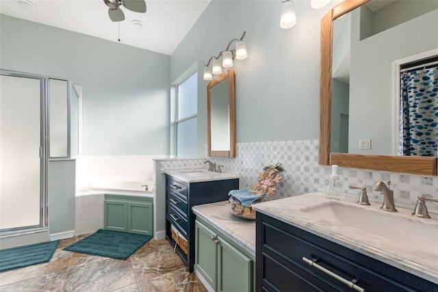 bathroom with vanity, ceiling fan, plus walk in shower, and tasteful backsplash