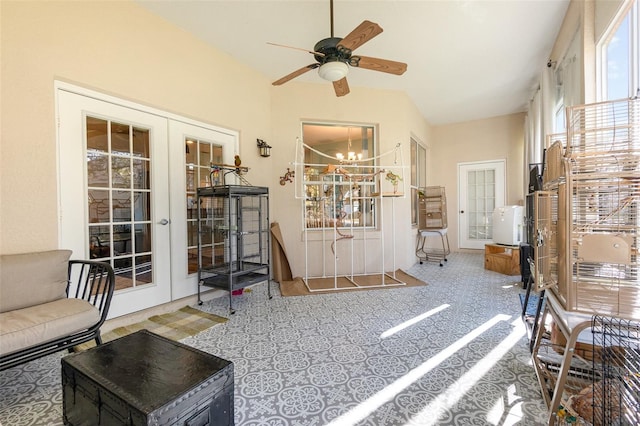 interior space with ceiling fan with notable chandelier, lofted ceiling, and french doors