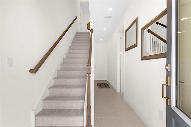 stairway featuring tile patterned flooring