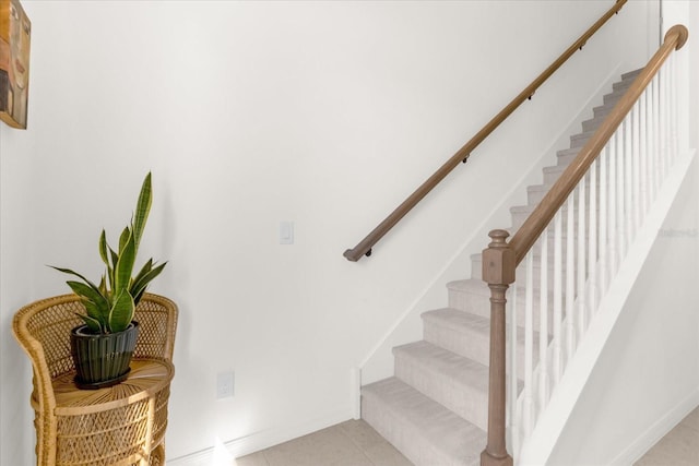 stairway with tile patterned floors