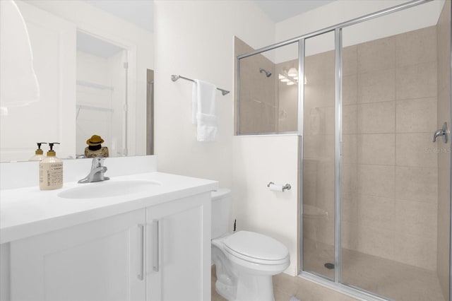 bathroom featuring tile patterned floors, vanity, an enclosed shower, and toilet