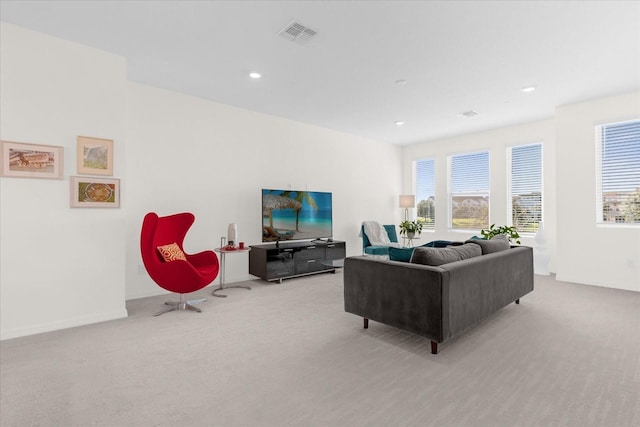 living room with light colored carpet and a wealth of natural light