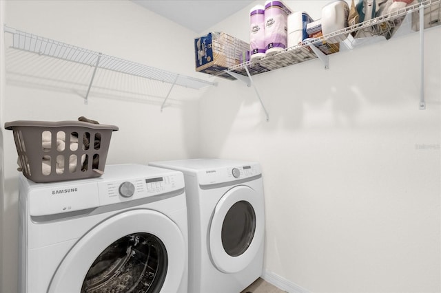 clothes washing area with washing machine and dryer