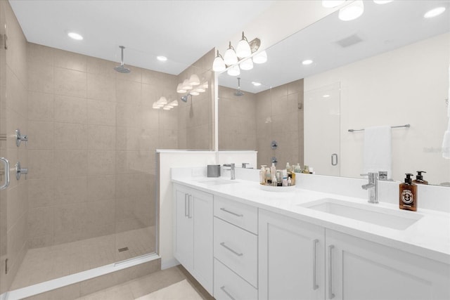 bathroom with tile patterned flooring, vanity, and a shower with shower door