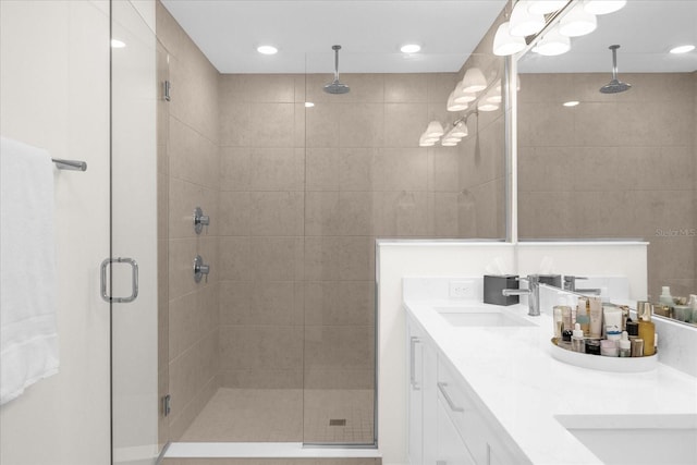 bathroom with vanity and a shower with shower door