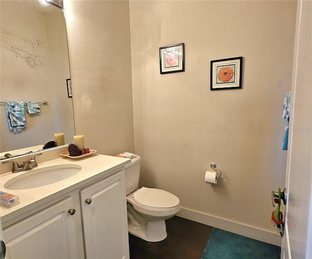 bathroom featuring tile patterned floors, vanity, and toilet