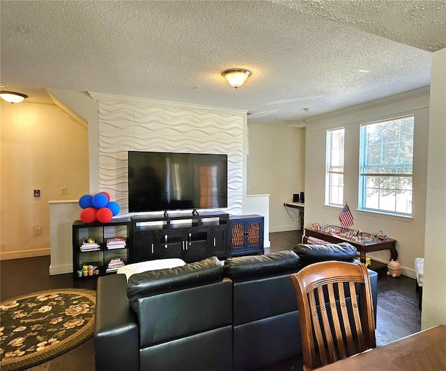 living room featuring a textured ceiling, crown molding, and dark wood-type flooring