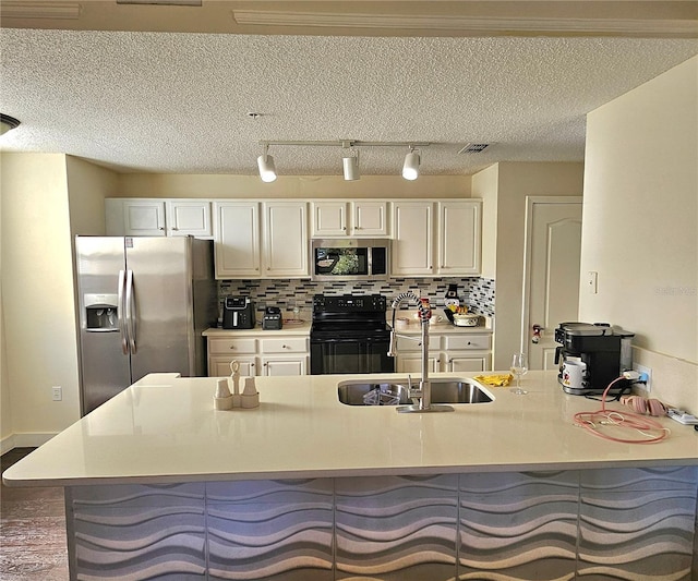 kitchen with white cabinetry, sink, stainless steel appliances, a breakfast bar area, and decorative backsplash