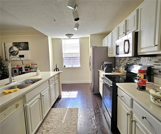 kitchen featuring white cabinetry, sink, dark hardwood / wood-style floors, a textured ceiling, and appliances with stainless steel finishes