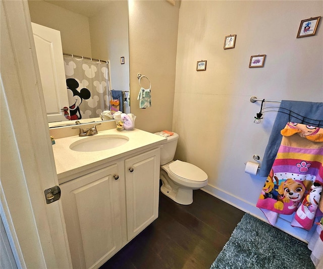 bathroom featuring hardwood / wood-style floors, vanity, and toilet