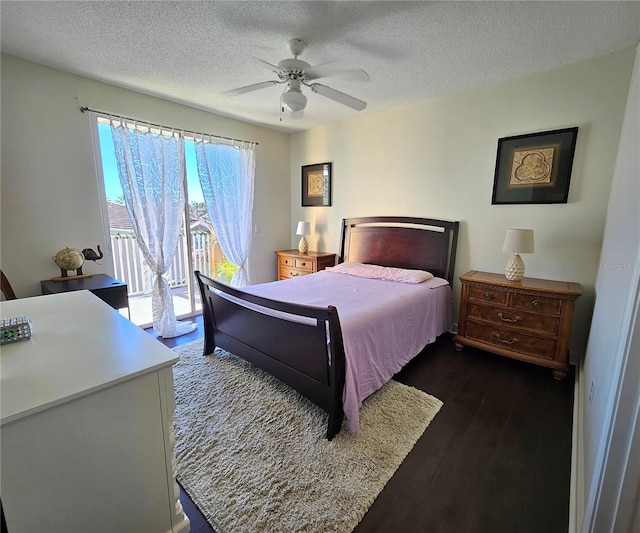 bedroom with a textured ceiling, access to outside, ceiling fan, and dark hardwood / wood-style floors