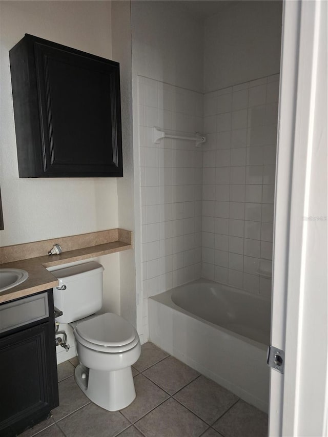 full bathroom with tile patterned floors, vanity, tiled shower / bath combo, and toilet