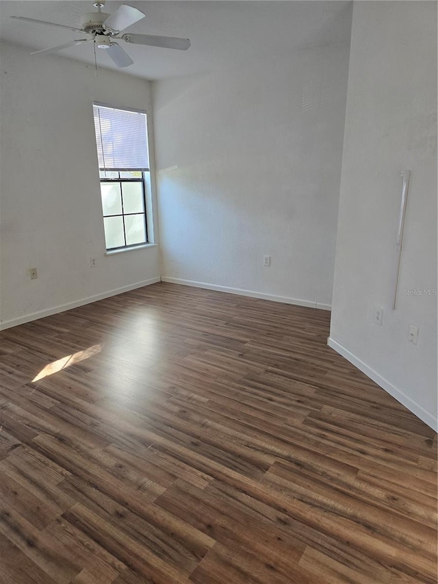 empty room featuring dark hardwood / wood-style flooring and ceiling fan