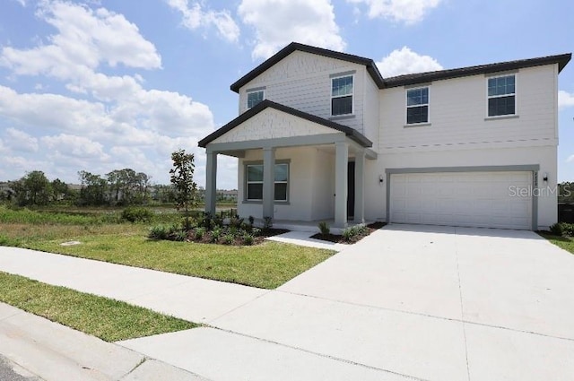 view of front of home featuring a front yard and a garage