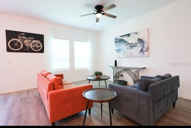 living room featuring hardwood / wood-style floors and ceiling fan