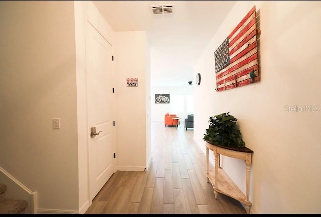 hall with hardwood / wood-style flooring