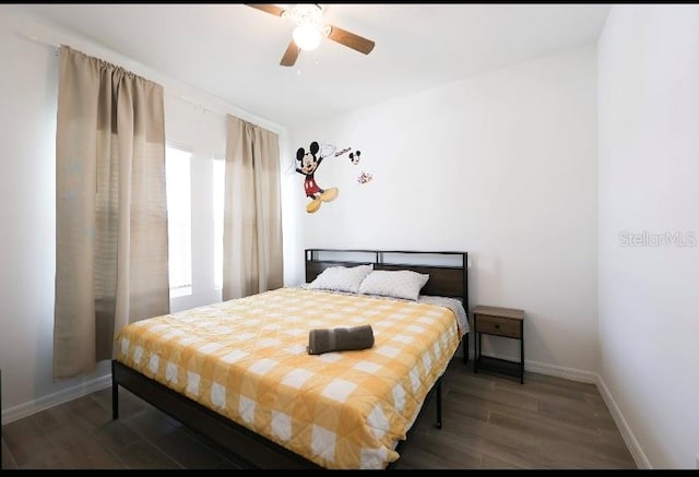 bedroom featuring ceiling fan and dark wood-type flooring