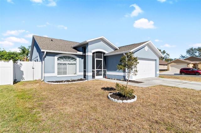 single story home with a garage and a front lawn