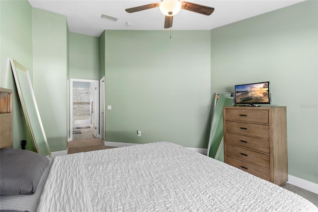 carpeted bedroom with connected bathroom and ceiling fan