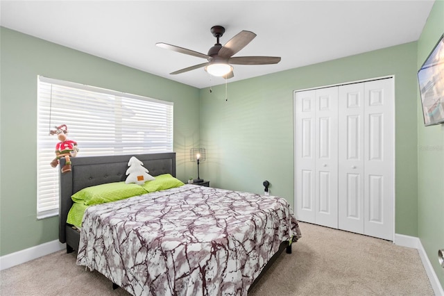 carpeted bedroom with a closet and ceiling fan