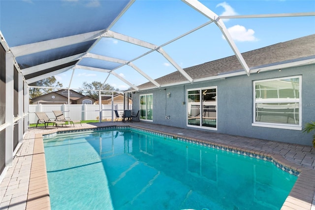 view of pool featuring a patio and glass enclosure