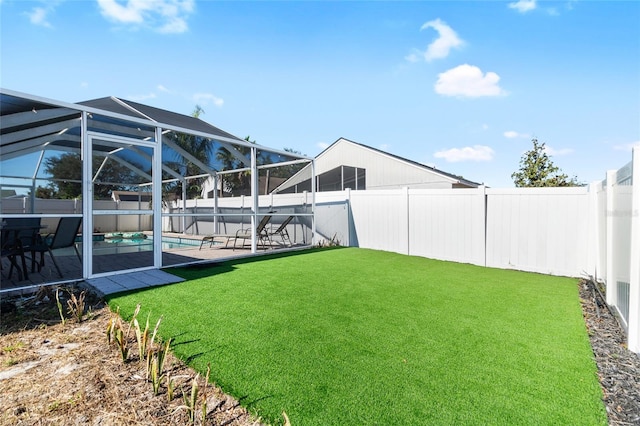 view of yard with a fenced in pool, glass enclosure, and a patio area