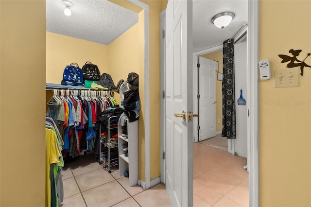 walk in closet featuring light tile patterned floors