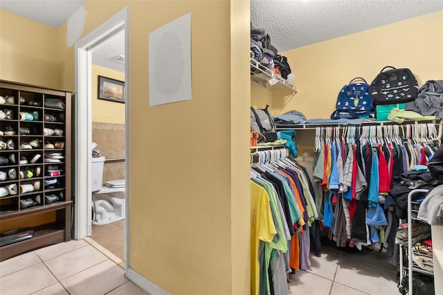 spacious closet featuring tile patterned floors