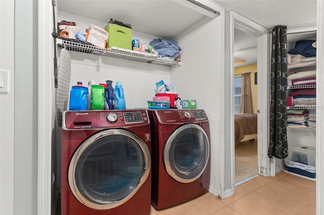 laundry room with light tile patterned floors, a textured ceiling, and independent washer and dryer