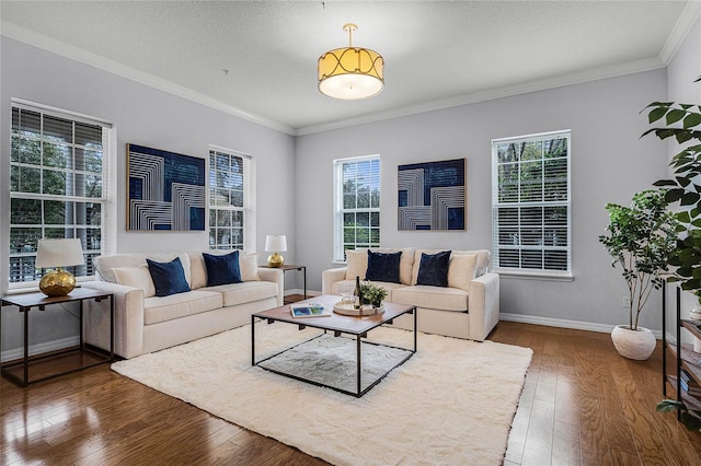 living room with hardwood / wood-style flooring, plenty of natural light, and crown molding