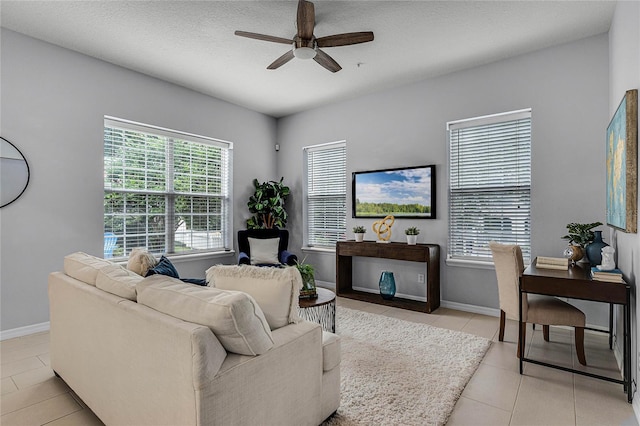 tiled living room with ceiling fan and a textured ceiling