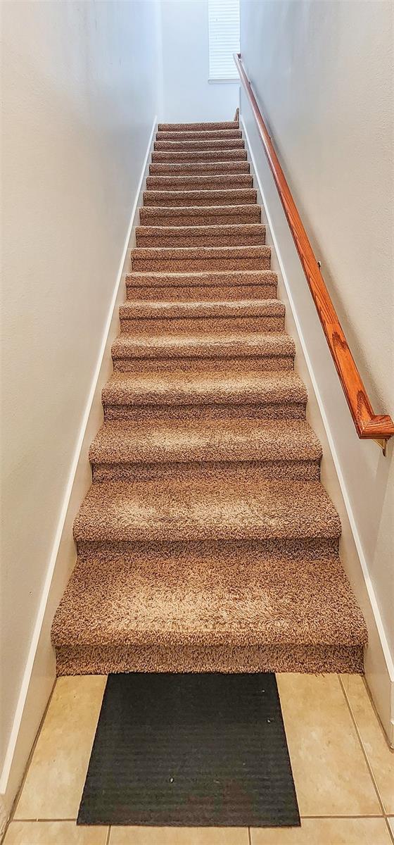 stairs featuring tile patterned flooring