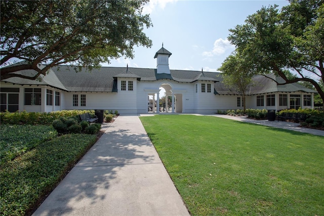 view of front of house with french doors and a front lawn