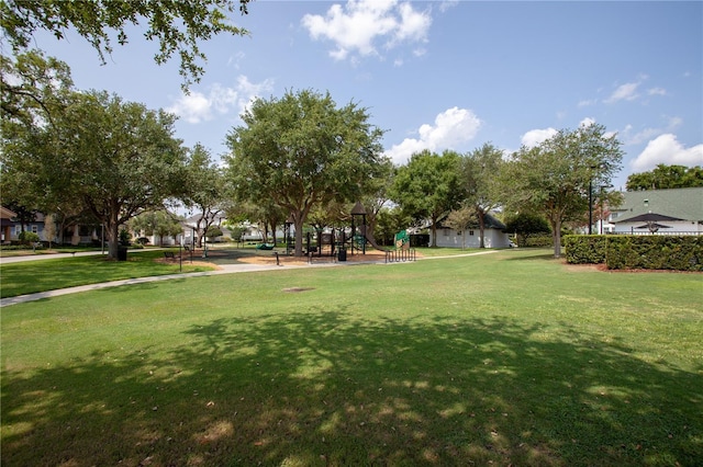 view of community featuring a lawn and a playground