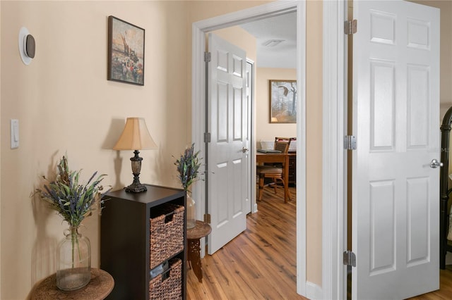 hall with light wood-style flooring and visible vents