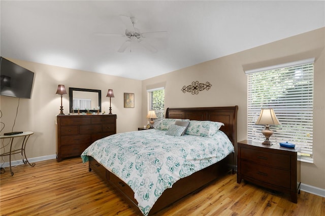 bedroom featuring ceiling fan, light wood-type flooring, and baseboards