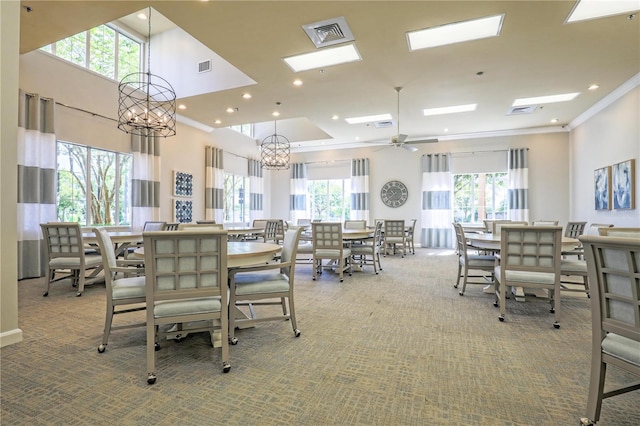 carpeted dining area with ornamental molding, plenty of natural light, and visible vents