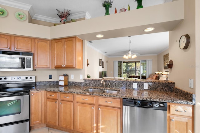 kitchen with appliances with stainless steel finishes, a sink, and crown molding