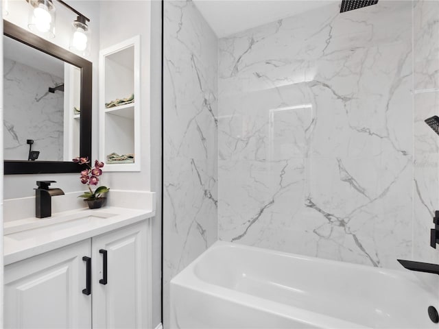 bathroom with vanity and tiled shower / bath