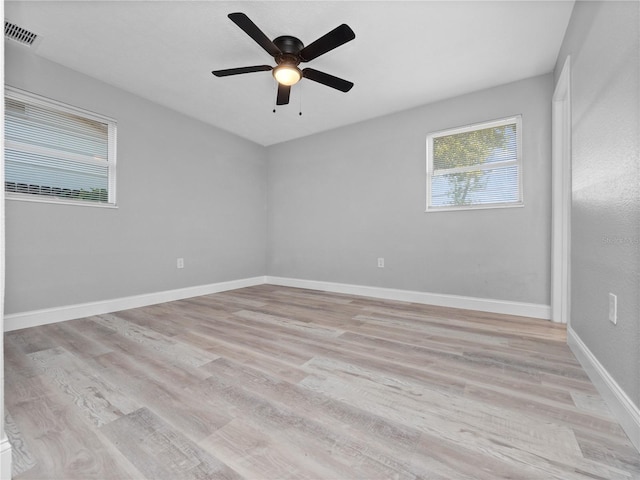 spare room with light wood-type flooring and ceiling fan