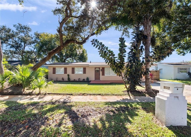 ranch-style house with a front lawn