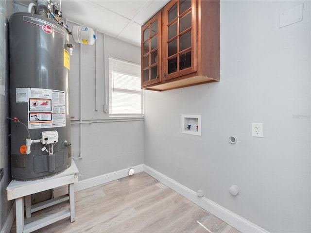 laundry area with washer hookup, gas water heater, electric dryer hookup, hookup for a gas dryer, and light hardwood / wood-style floors