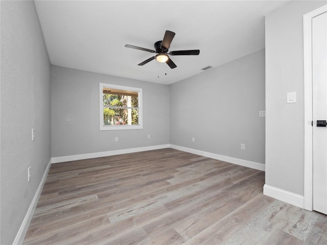 spare room with light hardwood / wood-style floors and ceiling fan